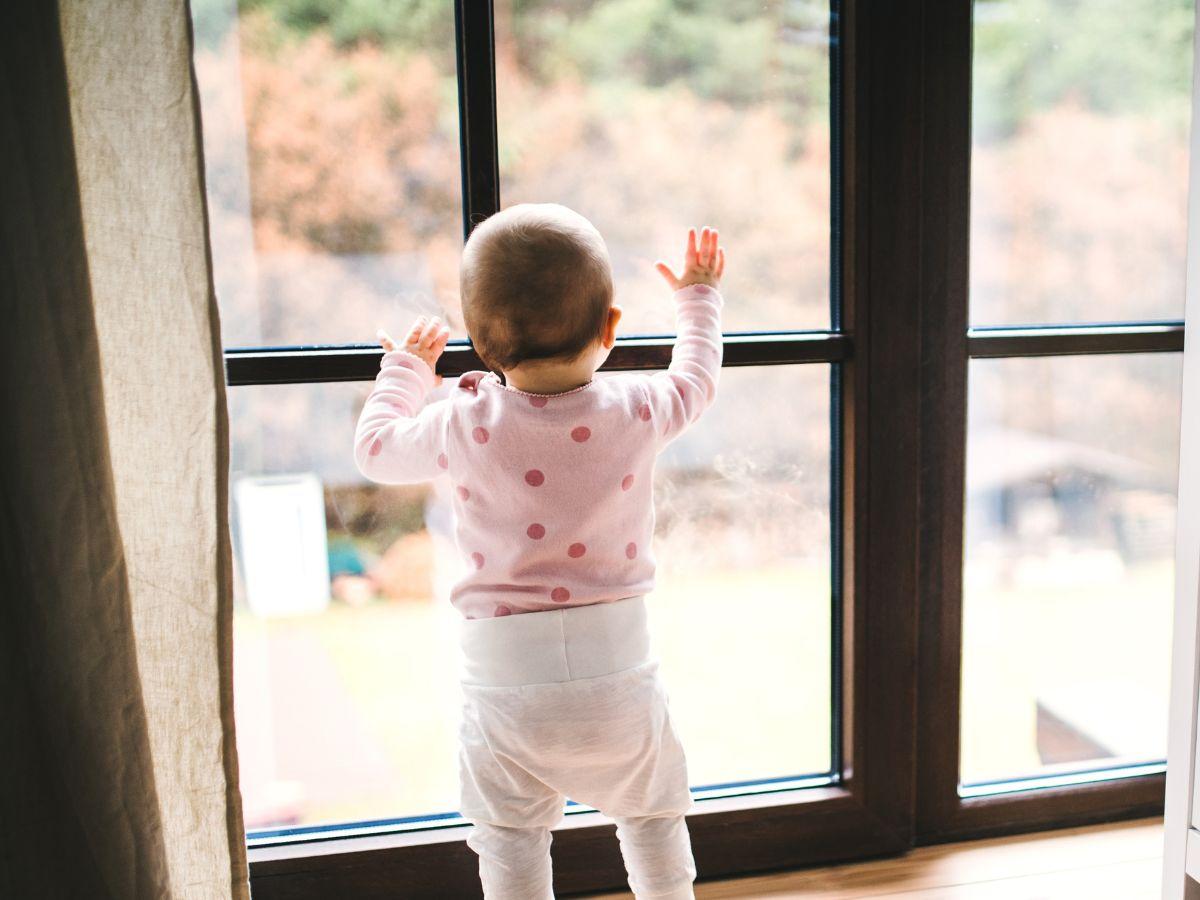 Toddler looking out of window